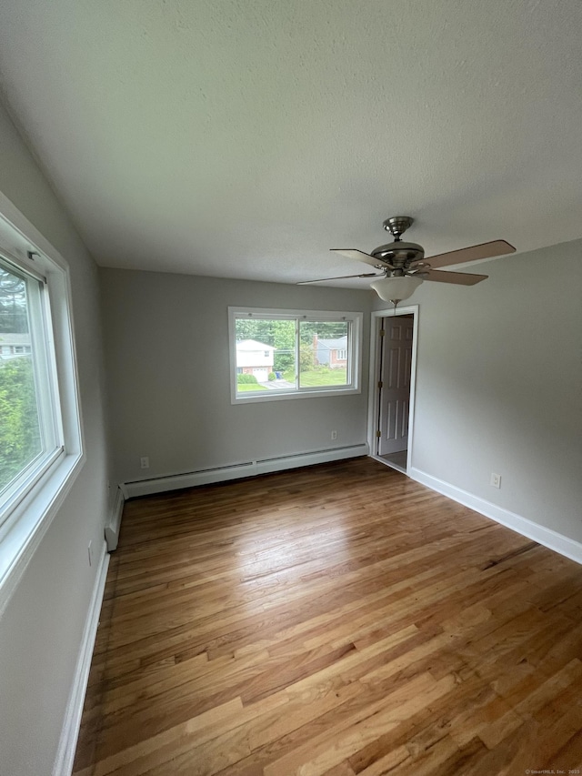 37 W Normandy Dr, West Hartford, CT 06107 - unfurnished room featuring a baseboard radiator, light wood-style floors, ceiling fan, and a textured ceiling
