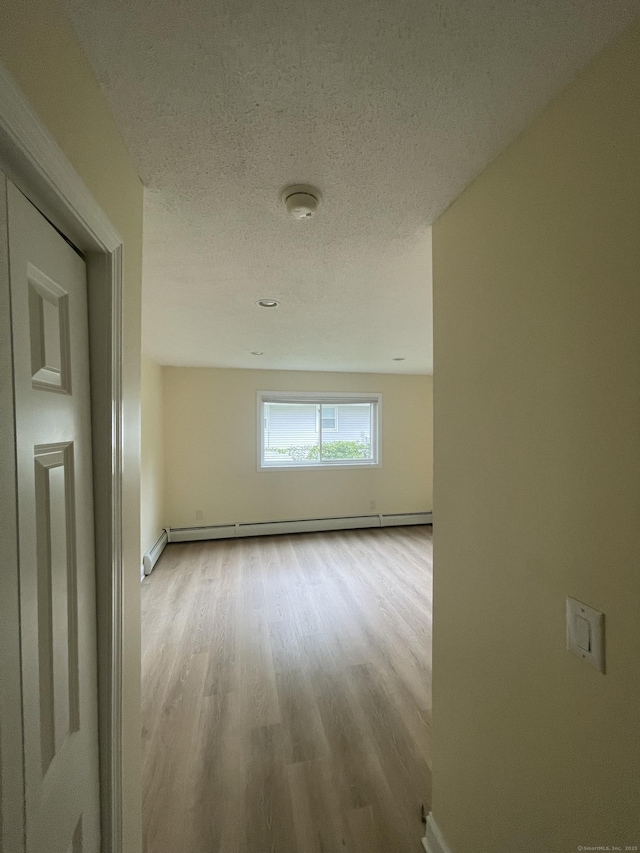37 W Normandy Dr, West Hartford, CT 06107 - hall featuring a baseboard heating unit, wood finished floors, and a textured ceiling