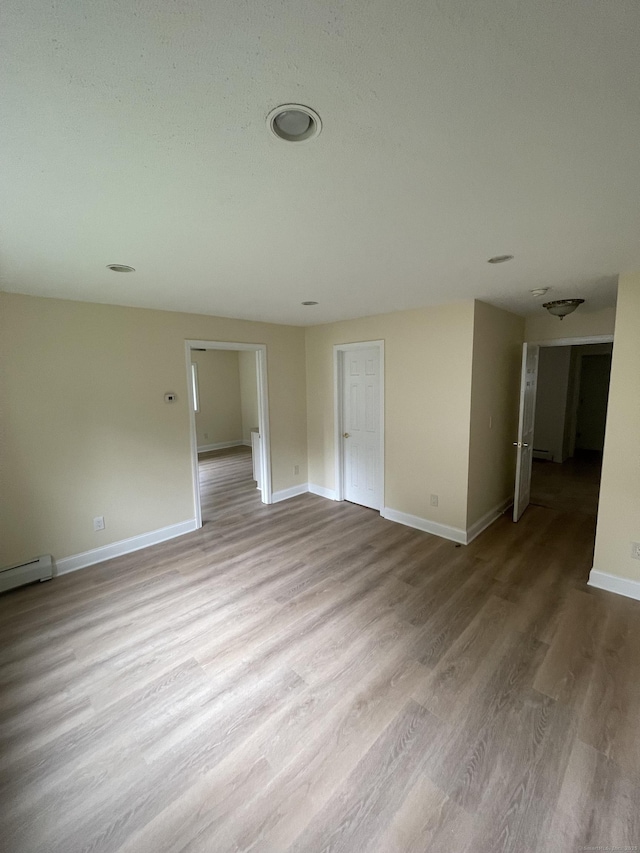 37 W Normandy Dr, West Hartford, CT 06107 - unfurnished room featuring wood finished floors and a baseboard heating unit