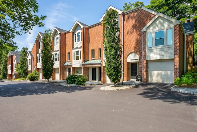 10 Pine Brook Ln Unit 10, Darien, CT 06820 - view of front of house featuring brick siding, a residential view, and an attached garage