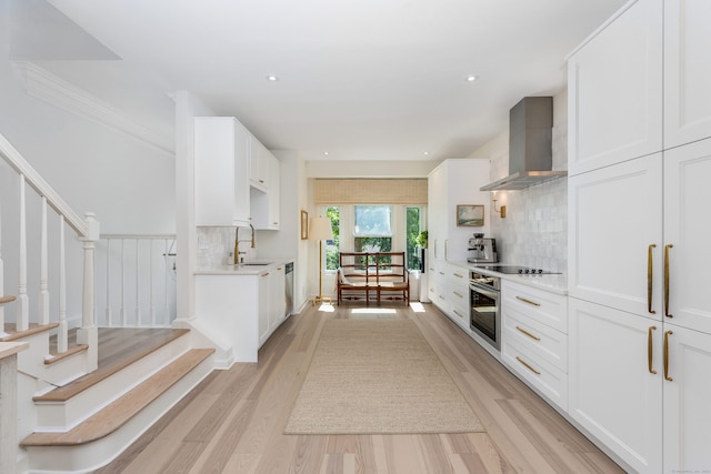 10 Pine Brook Ln Unit 10, Darien, CT 06820 - kitchen featuring wall chimney range hood, stainless steel appliances, backsplash, light countertops, and white cabinets