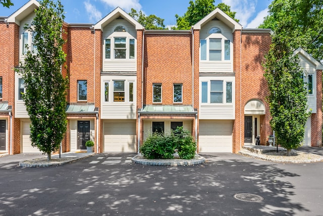 10 Pine Brook Ln Unit 10, Darien, CT 06820 - view of front of house featuring an attached garage, brick siding, and driveway