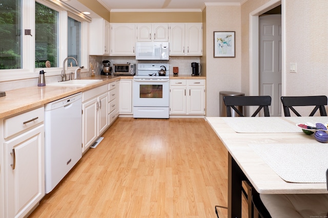 29 S Village Rd Unit 29, Branford, CT 06405 - kitchen with white appliances, ornamental molding, light wood finished floors, white cabinets, and light countertops