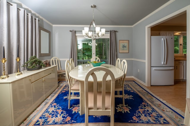 29 S Village Rd Unit 29, Branford, CT 06405 - dining area featuring a chandelier, ornamental molding, and light wood-type flooring