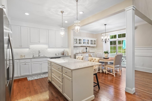 7 Still Water Cir Unit 7, Brookfield, CT 06804 - kitchen with stainless steel fridge with ice dispenser, crown molding, a kitchen breakfast bar, white cabinetry, and a kitchen island