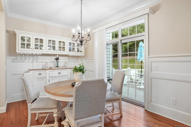 7 Still Water Cir Unit 7, Brookfield, CT 06804 - dining area with ornamental molding, a decorative wall, a chandelier, wood finished floors, and a wainscoted wall
