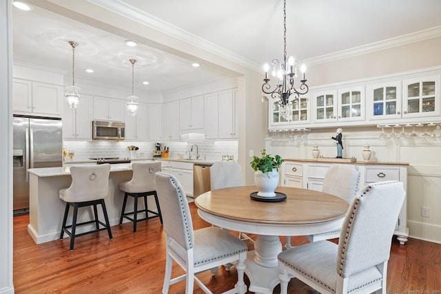 7 Still Water Cir Unit 7, Brookfield, CT 06804 - dining area featuring wood finished floors, ornamental molding, a chandelier, and recessed lighting