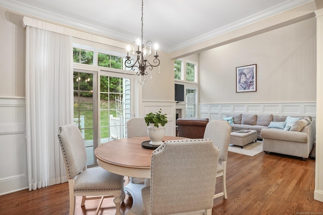 7 Still Water Cir Unit 7, Brookfield, CT 06804 - dining space featuring a decorative wall, crown molding, a chandelier, wood finished floors, and wainscoting
