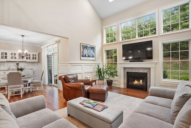 7 Still Water Cir Unit 7, Brookfield, CT 06804 - living room featuring a chandelier, a tiled fireplace, healthy amount of natural light, high vaulted ceiling, and wood finished floors