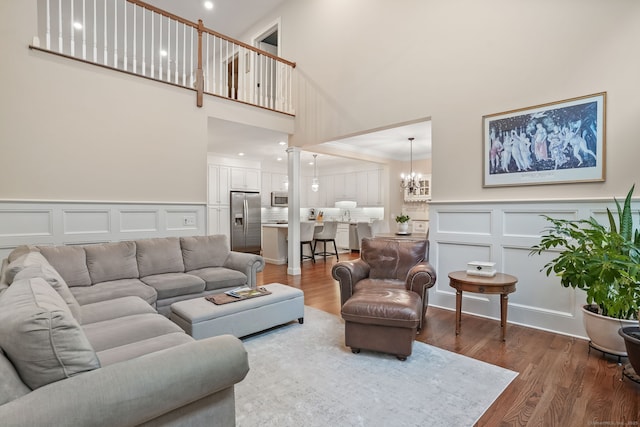 7 Still Water Cir Unit 7, Brookfield, CT 06804 - living area with a decorative wall, a high ceiling, wood finished floors, a chandelier, and ornamental molding