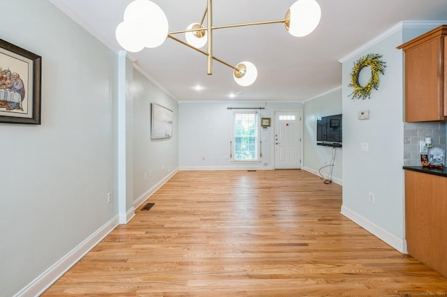 38 Stuart Ave Apt C, Norwalk, CT 06850 - unfurnished living room with crown molding, light wood-style flooring, and a chandelier
