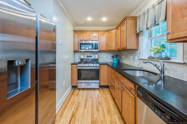 38 Stuart Ave Apt C, Norwalk, CT 06850 - kitchen featuring appliances with stainless steel finishes, crown molding, light wood-style floors, brown cabinets, and tasteful backsplash