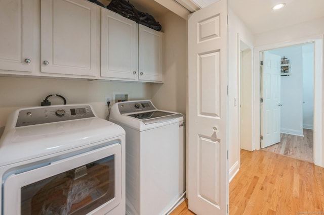 38 Stuart Ave Apt C, Norwalk, CT 06850 - laundry area featuring cabinet space, separate washer and dryer, light wood-style flooring, and recessed lighting