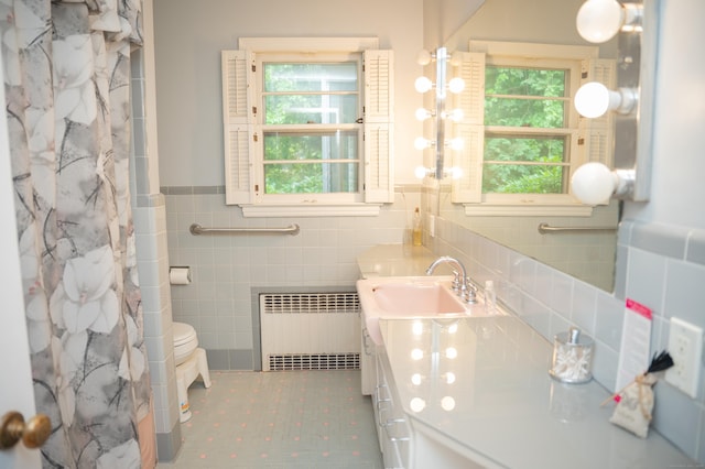 780 Ridge Rd, Hamden, CT 06517 - bathroom with radiator heating unit, tile walls, plenty of natural light, vanity, and wainscoting