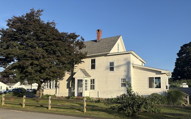 53 Smith St, East Lyme, CT 06357 - view of home's exterior featuring a chimney and roof with shingles