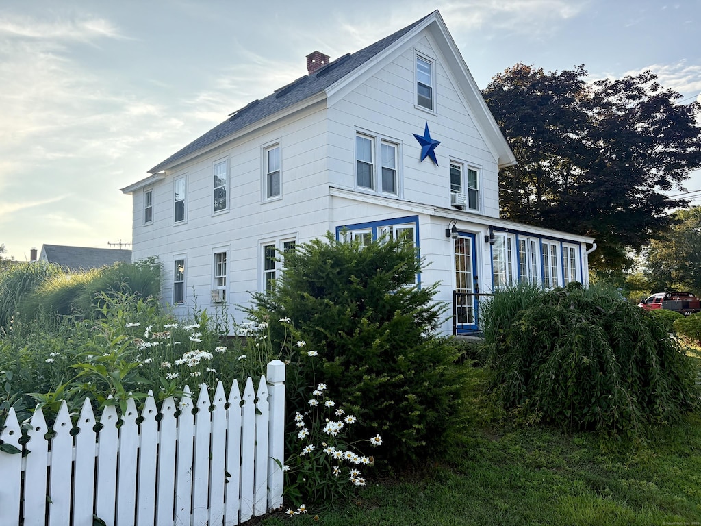 53 Smith St, East Lyme, CT 06357 - view of side of property with a chimney