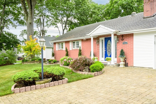 92 Grove Beach Rd S, Westbrook, CT 06498 - ranch-style home with a shingled roof, brick siding, a front yard, and a chimney