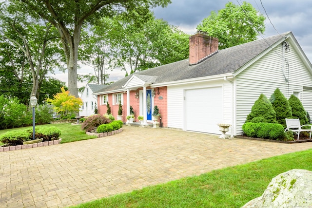 92 Grove Beach Rd S, Westbrook, CT 06498 - single story home featuring a garage, a chimney, decorative driveway, a shingled roof, and a front lawn
