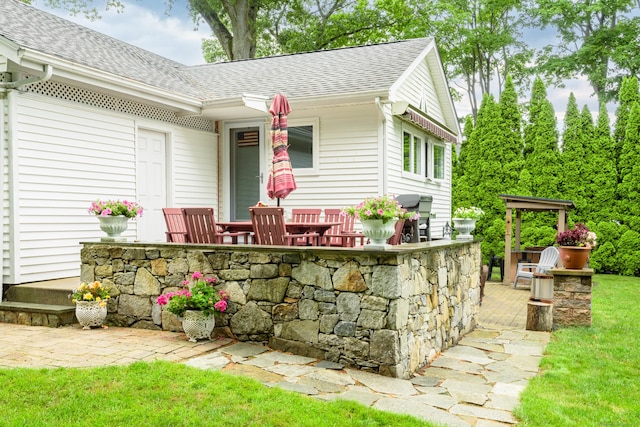 92 Grove Beach Rd S, Westbrook, CT 06498 - exterior space with a shingled roof, a front lawn, and a deck