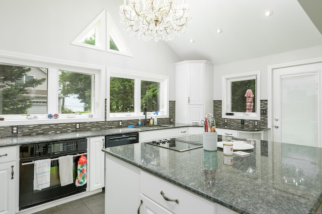 92 Grove Beach Rd S, Westbrook, CT 06498 - kitchen with tasteful backsplash, black appliances, a chandelier, white cabinetry, and lofted ceiling