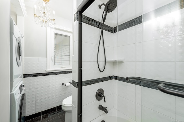 92 Grove Beach Rd S, Westbrook, CT 06498 - full bath featuring stacked washer / drying machine, shower / bath combination, tile walls, a chandelier, and tile patterned floors