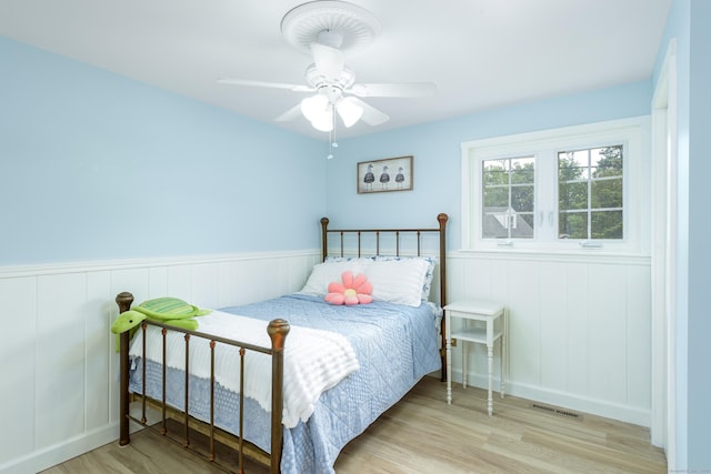 92 Grove Beach Rd S, Westbrook, CT 06498 - bedroom with wood finished floors, a wainscoted wall, and a ceiling fan