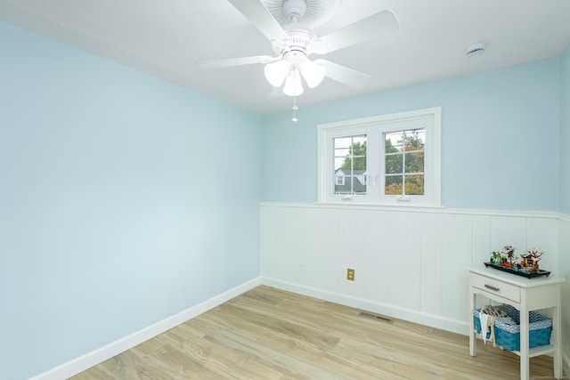92 Grove Beach Rd S, Westbrook, CT 06498 - empty room featuring wood finished floors, a wainscoted wall, ceiling fan, and a smoke detector