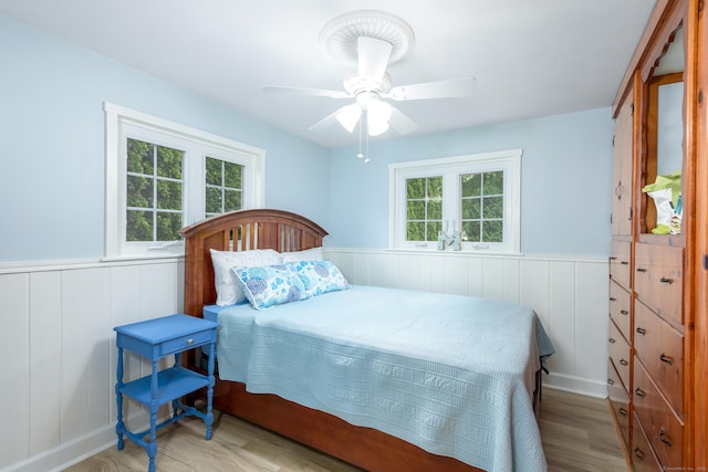 92 Grove Beach Rd S, Westbrook, CT 06498 - bedroom featuring wood finished floors, wainscoting, and ceiling fan