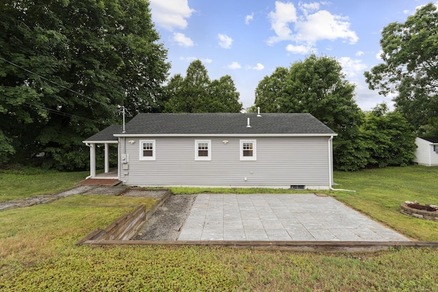 5 Fuller Ct, East Lyme, CT 06357 - back of property featuring a lawn, a patio, roof with shingles, and an outdoor fire pit