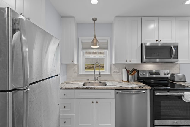 5 Fuller Ct, East Lyme, CT 06357 - kitchen featuring appliances with stainless steel finishes, white cabinets, backsplash, and light stone counters