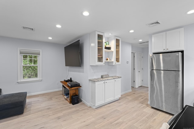 5 Fuller Ct, East Lyme, CT 06357 - kitchen featuring freestanding refrigerator, white cabinetry, light stone countertops, light wood-type flooring, and recessed lighting