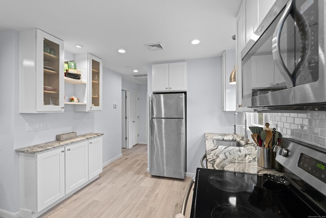 5 Fuller Ct, East Lyme, CT 06357 - kitchen featuring stainless steel appliances, white cabinets, decorative backsplash, glass insert cabinets, and recessed lighting