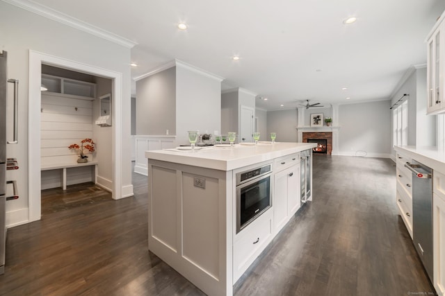 98A Tower Rd, Brookfield, CT 06804 - kitchen featuring ornamental molding, a center island with sink, beverage cooler, white cabinetry, and ceiling fan