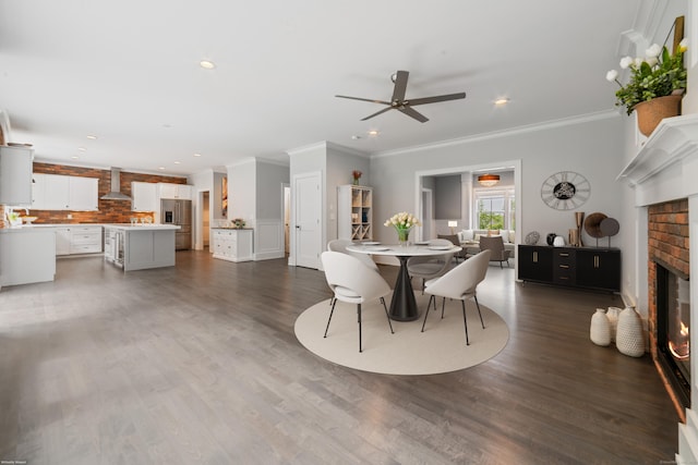 98A Tower Rd, Brookfield, CT 06804 - dining space featuring a fireplace, a ceiling fan, crown molding, recessed lighting, and dark wood-type flooring