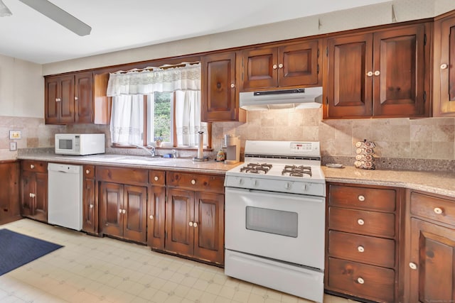 46 W St, Shelton, CT 06484 - kitchen featuring white appliances, under cabinet range hood, light countertops, backsplash, and light flooring