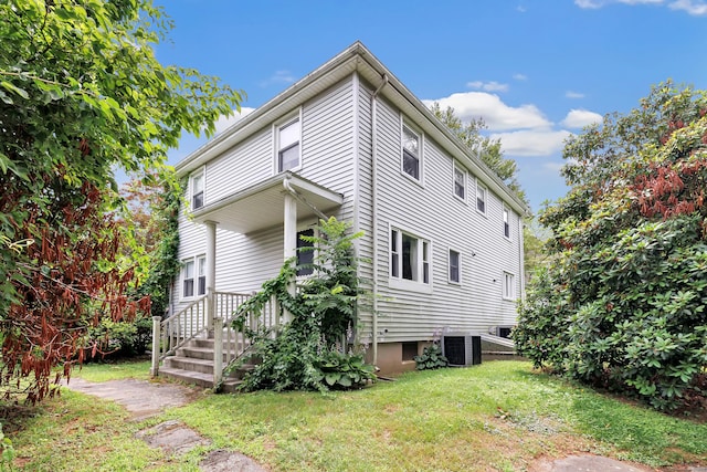 46 W St, Shelton, CT 06484 - view of side of home featuring a lawn and a cooling unit