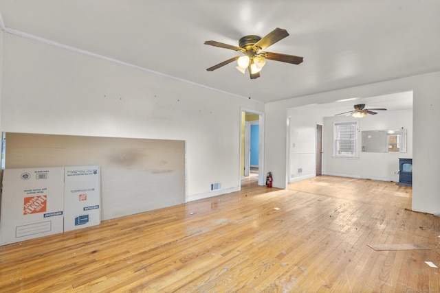 484 Reitter St W, Stratford, CT 06614 - unfurnished living room featuring a wood stove, a ceiling fan, and hardwood / wood-style flooring