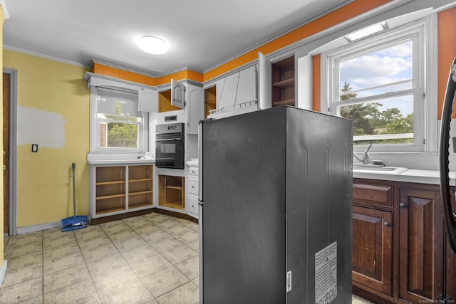 484 Reitter St W, Stratford, CT 06614 - kitchen with oven, plenty of natural light, light flooring, crown molding, and freestanding refrigerator