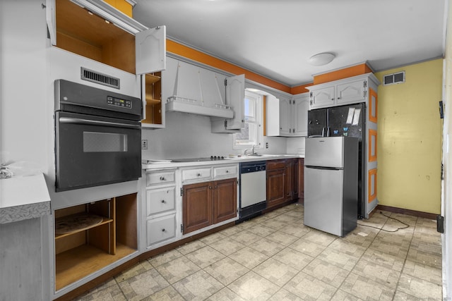 484 Reitter St W, Stratford, CT 06614 - kitchen with black appliances, open shelves, light countertops, and custom exhaust hood