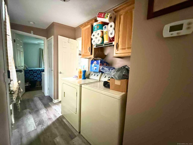 441 Main St Lot 1005, East Hartford, CT 06111 - laundry room featuring washing machine and clothes dryer, wood finished floors, and cabinet space
