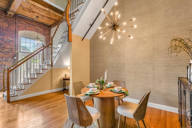 33 Mechanic St Unit 204, Windsor, CT 06095 - dining space featuring a chandelier, wood finished floors, stairs, a high ceiling, and beam ceiling
