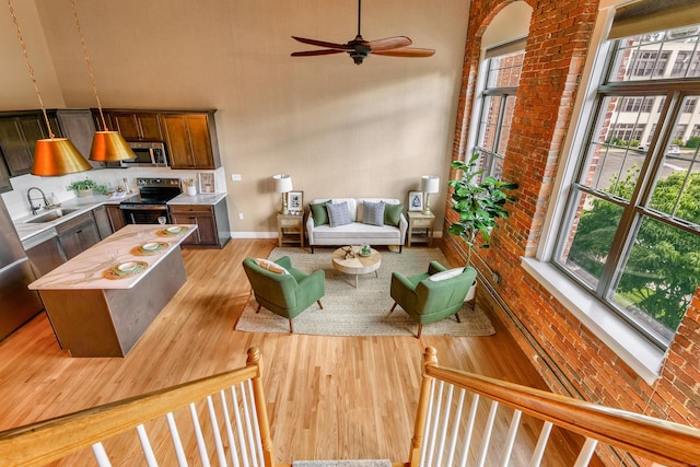 33 Mechanic St Unit 204, Windsor, CT 06095 - living area with light wood finished floors, ceiling fan, and a high ceiling