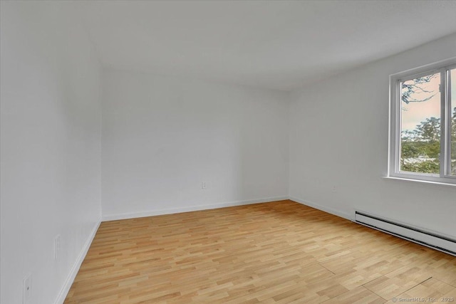 142 Burgundy Hill Ln Unit 142, Middletown, CT 06457 - spare room with light wood-style flooring and a baseboard radiator