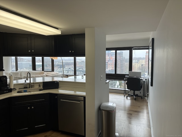 127 Greyrock Pl Apt 1401, Stamford, CT 06901 - kitchen featuring stainless steel dishwasher, light countertops, wood finished floors, dark cabinets, and a view of city