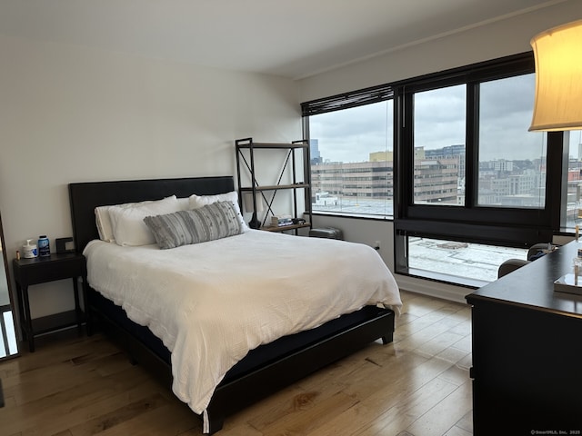 127 Greyrock Pl Apt 1401, Stamford, CT 06901 - bedroom with multiple windows, wood-type flooring, and a view of city
