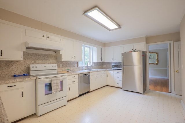 226 Stanwich Rd, Greenwich, CT 06830 - kitchen with appliances with stainless steel finishes, light countertops, decorative backsplash, white cabinetry, and custom exhaust hood