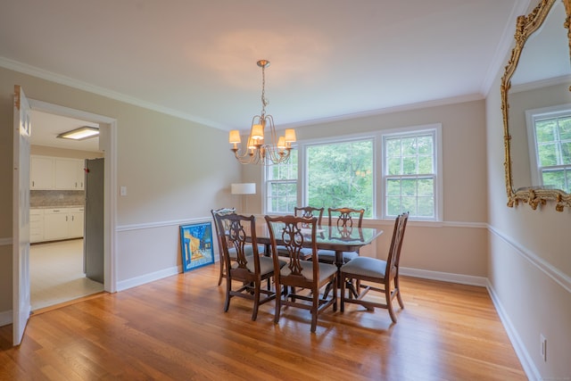 226 Stanwich Rd, Greenwich, CT 06830 - dining space with light wood-type flooring, a chandelier, and ornamental molding