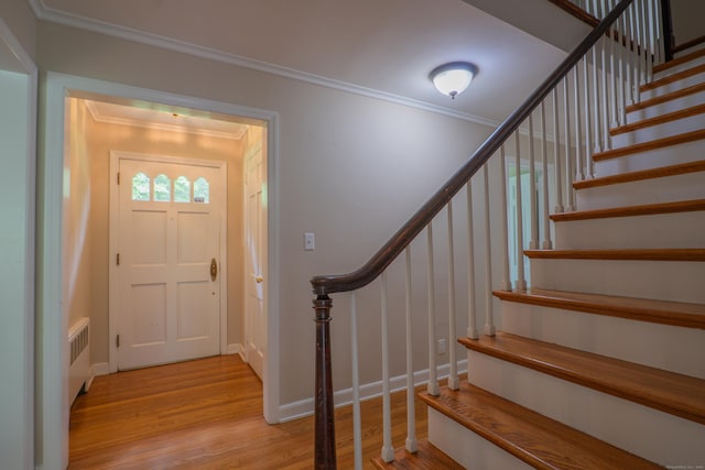 226 Stanwich Rd, Greenwich, CT 06830 - entryway featuring ornamental molding, light wood finished floors, stairway, and radiator