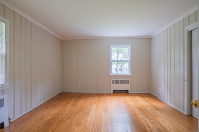 226 Stanwich Rd, Greenwich, CT 06830 - empty room with light wood finished floors, radiator heating unit, and ornamental molding