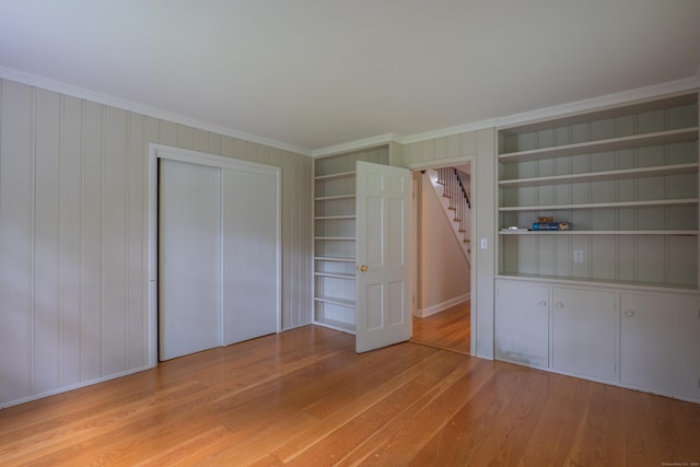 226 Stanwich Rd, Greenwich, CT 06830 - unfurnished bedroom featuring light wood-type flooring, ornamental molding, and a closet